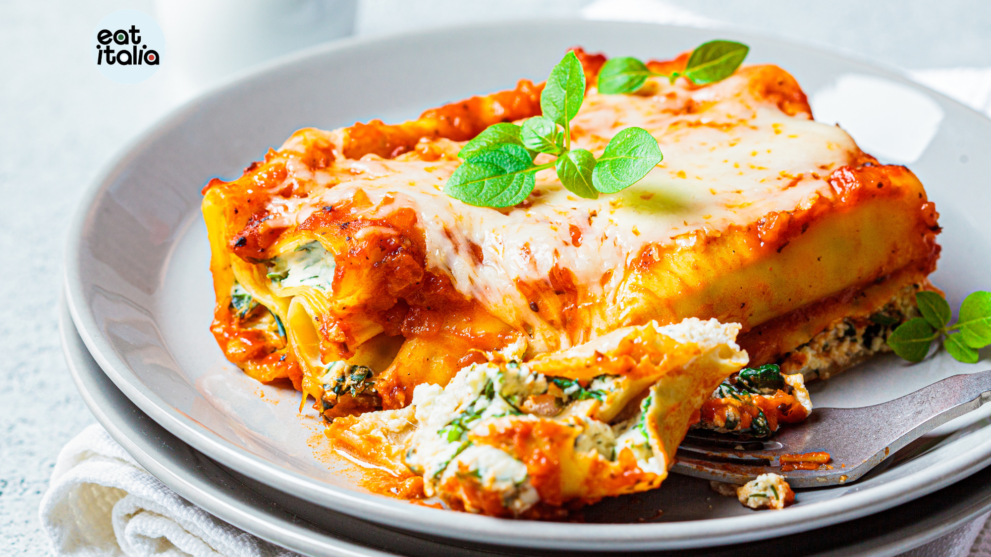 Baked Cannelloni showing spinach and ricotta filling