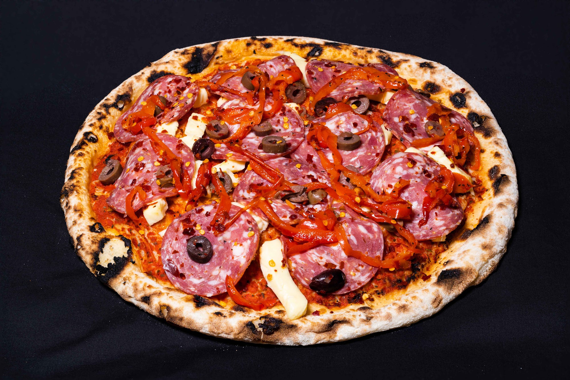 Fresh piccante pizza on a dark background