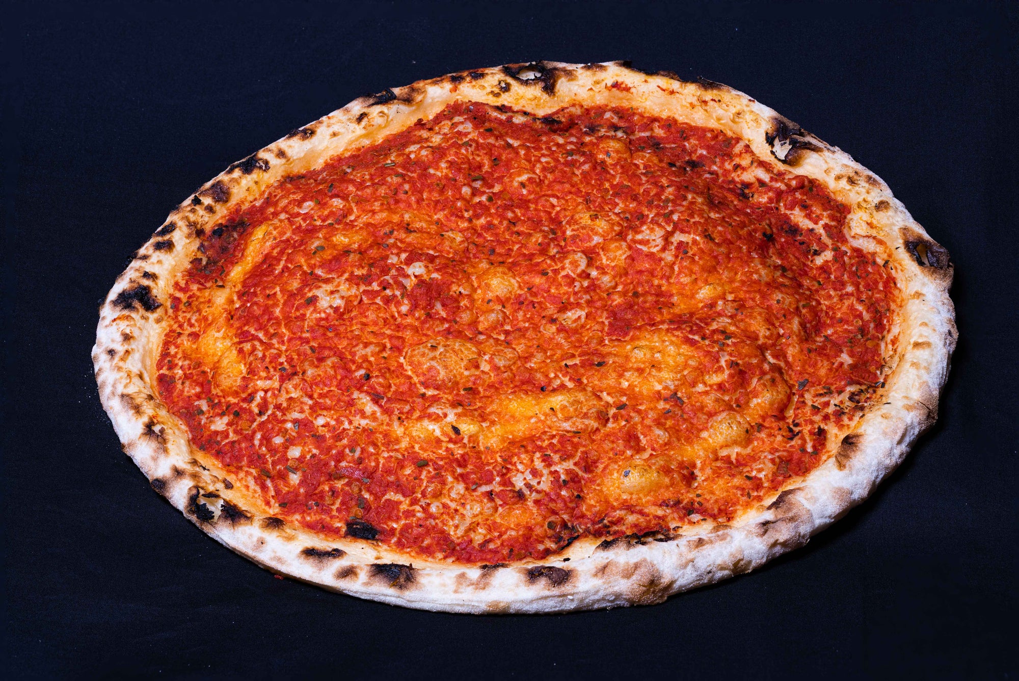 A wood-fired pizza with a plain base and tomato sauce topping.