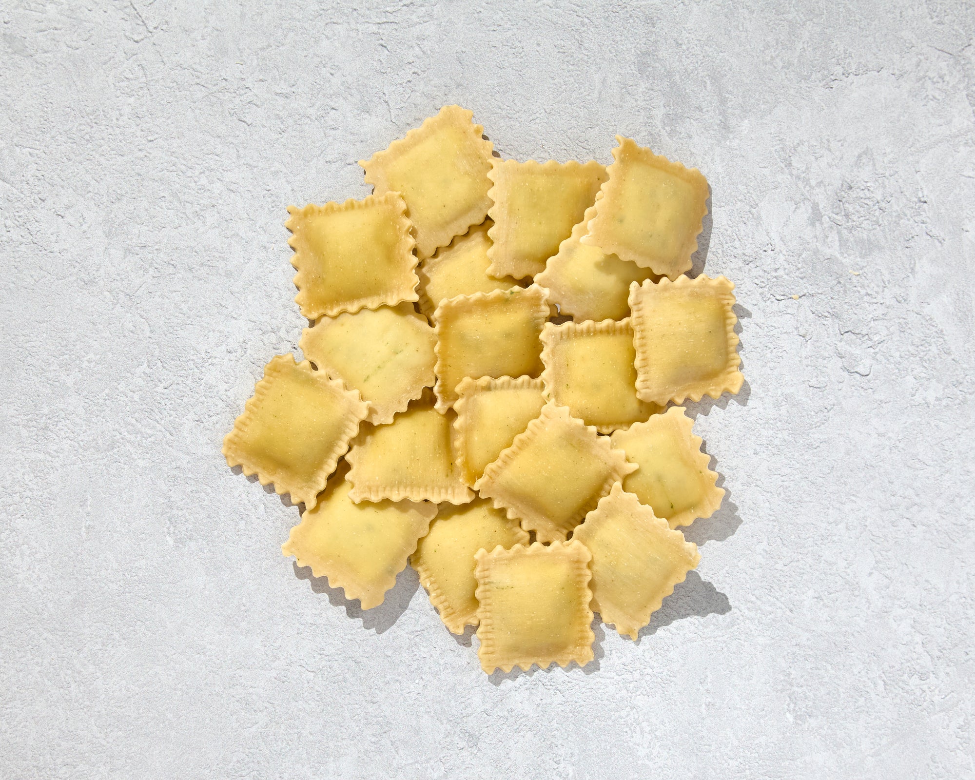 Pile of fresh ravioli spinach and ricotta ready for cooking